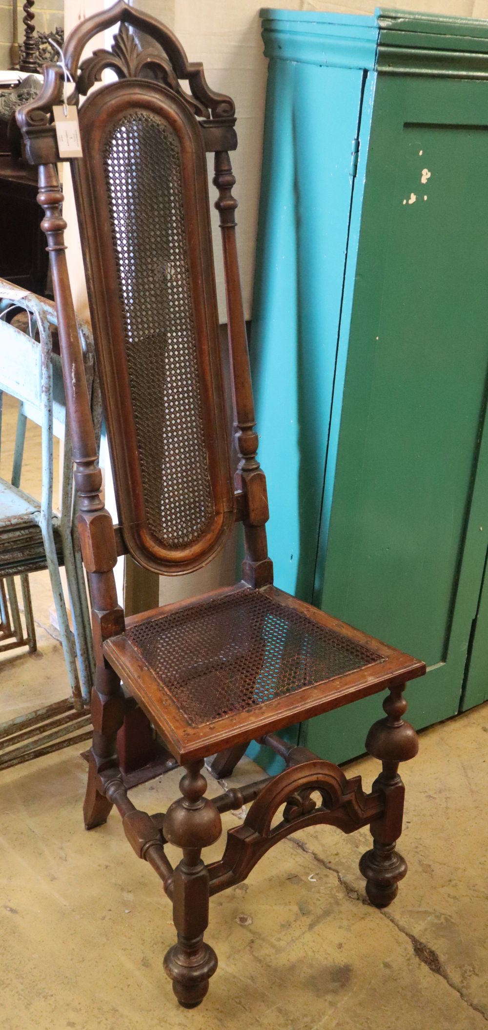 A Carolean-style carved walnut caned high back chair